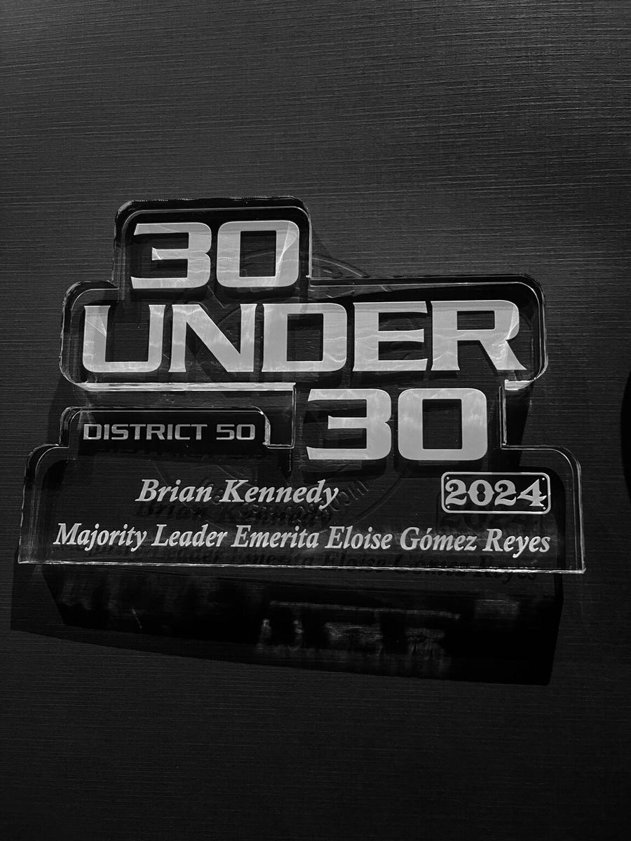 Clear acrylic award reading "30 Under 30, District 50, Brian Kennedy, 2024, Majority Leader Emerita Eloise Gómez Reyes"