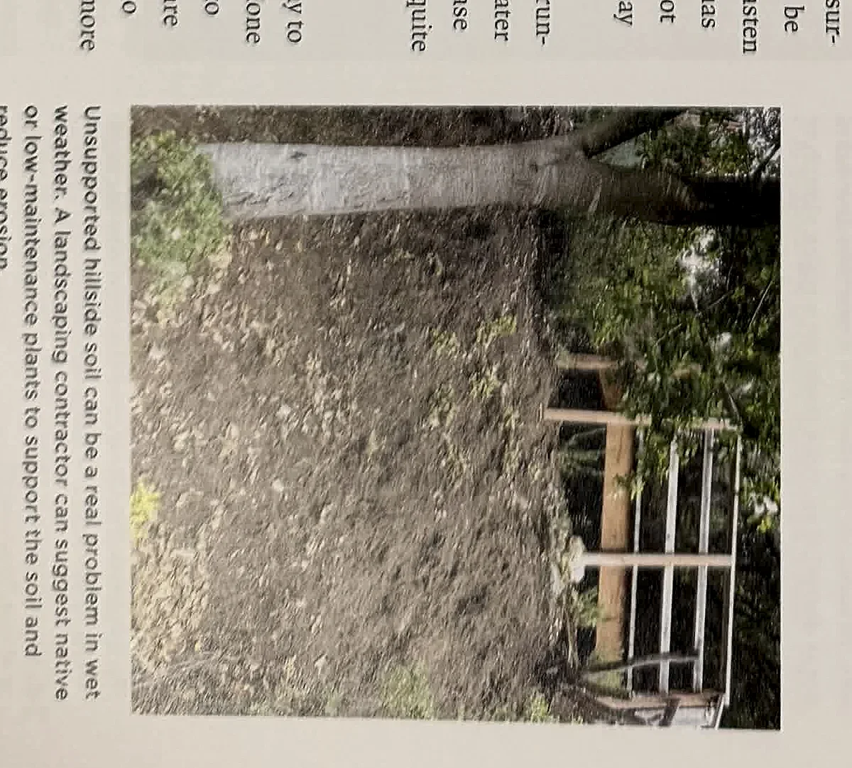 A cropped textbook photo showing soil grade and a runoff path near an exterior structure.