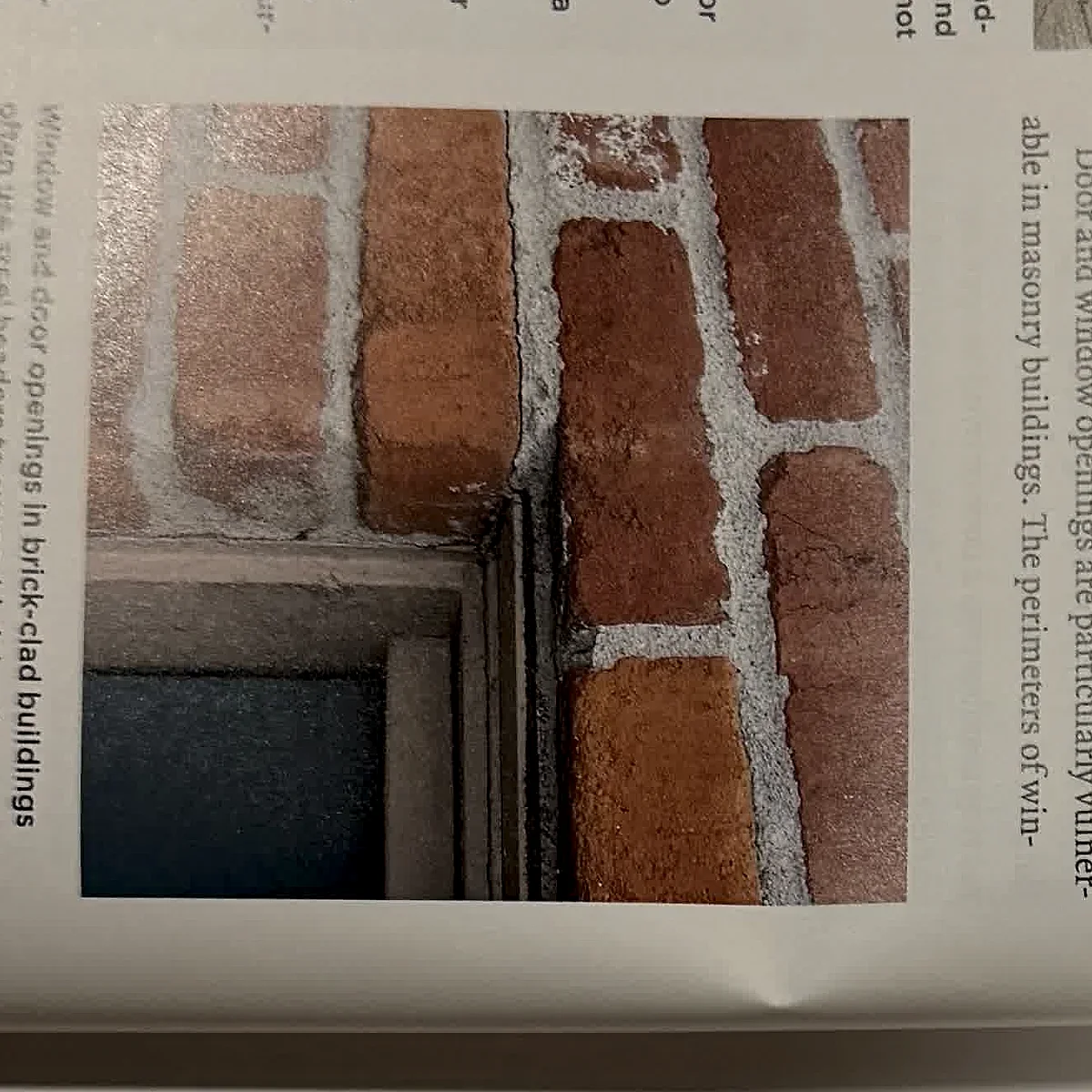 A cropped textbook photo showing brickwork and a window opening.