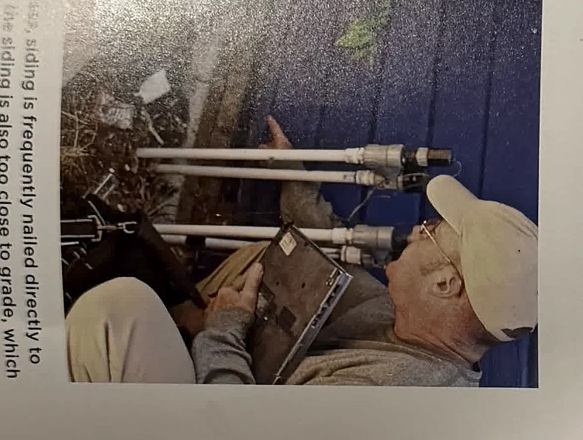 A cropped textbook photo of an inspector checking exterior building components.