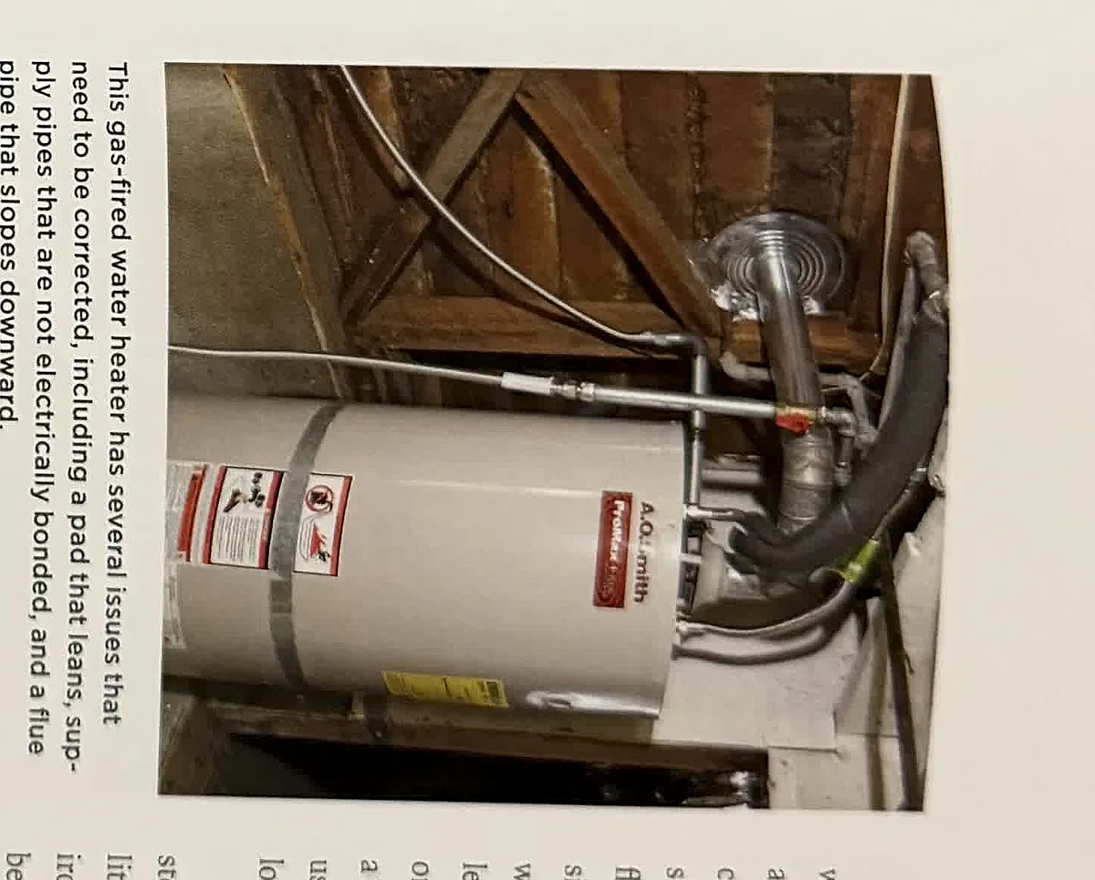 A cropped textbook photo of a water heater and visible piping.