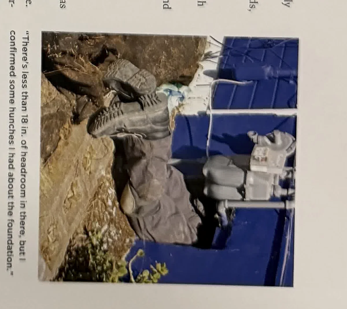 A cropped textbook photo showing workers near an exterior utility or excavation area.
